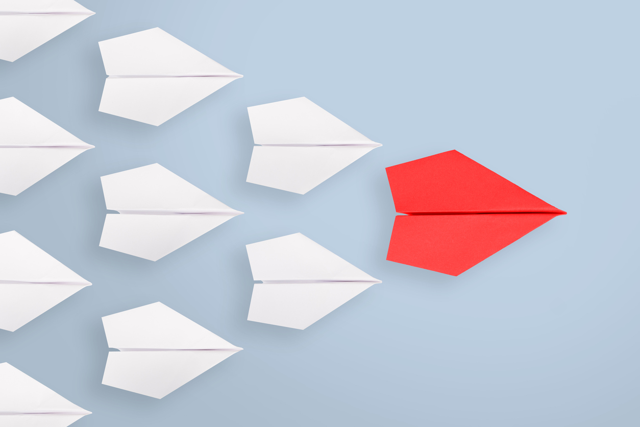 Leadership concepts with blue paper airplane